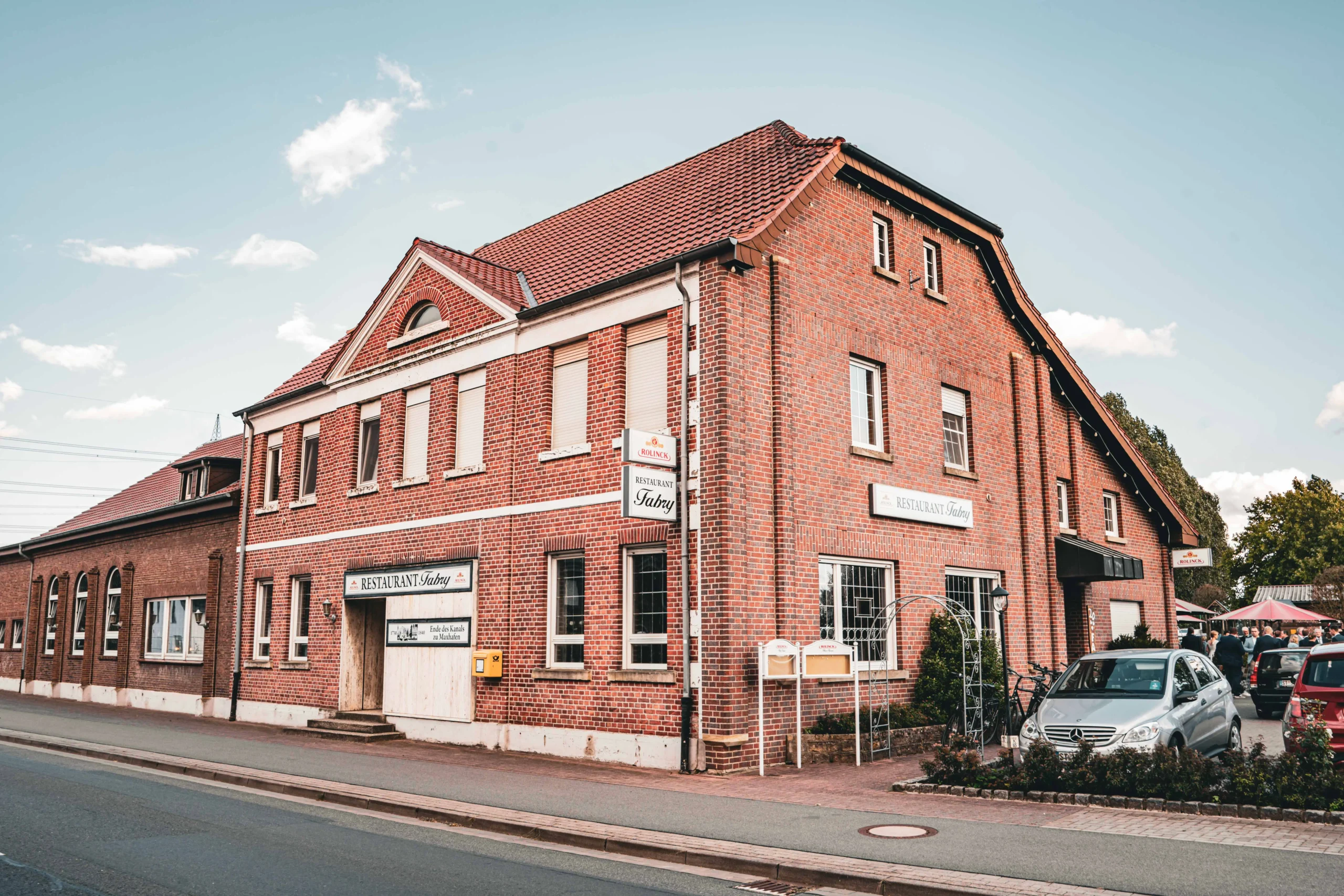 Backsteingebäude mit großen Fenstern und seitlicher Ansicht.